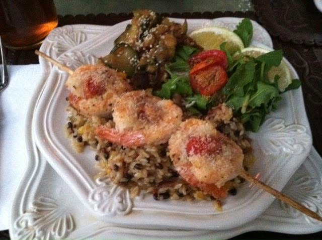 Coconut prawns skewers  baby tomatoes wild brown rice oranges dates Tahitian zucchini banana and onion mash arugala salad mango balsamic dressing