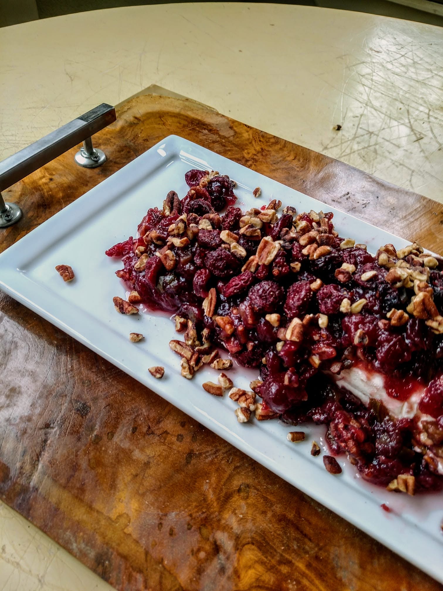 Cream cheese covered with cranberries, jalapenos and pecans