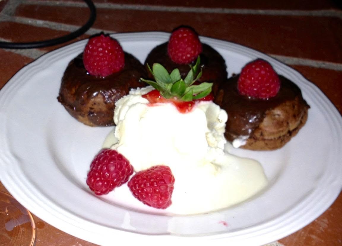 Dark chocolate mini cakes with raspberry filling and chocolate glaze, Vanilla ice cream and fresh raspberries
