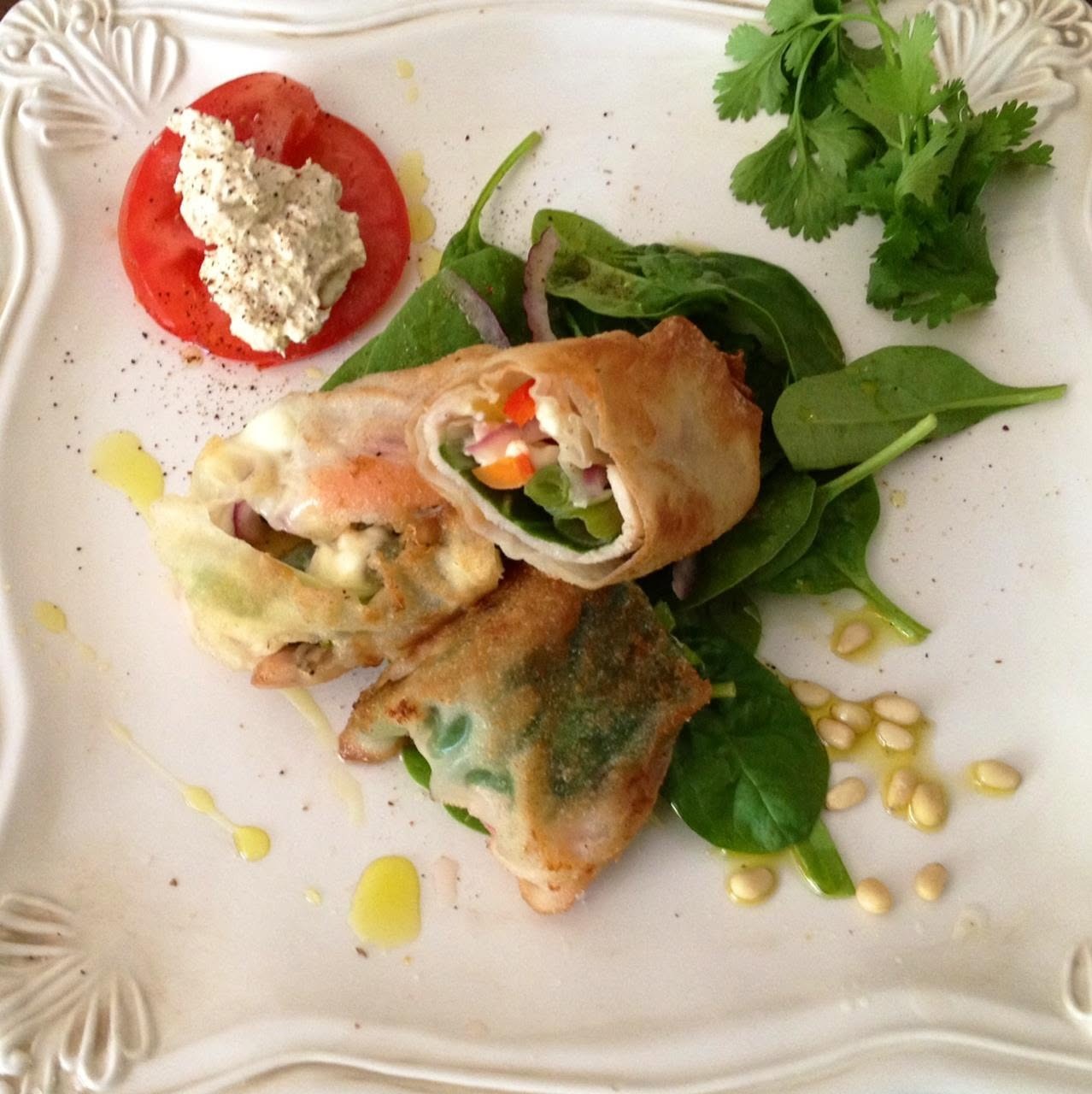 Final product, turkey. Spinach, yellow peppers, carrots, red and green onions in wanton wraps on a simple spinach salad