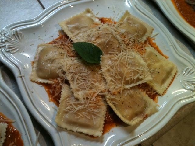 Organic buffalo mozzarella basel ravioli in a roasted garlic, tomato base with grated parmesan and fresh cracked black pepper