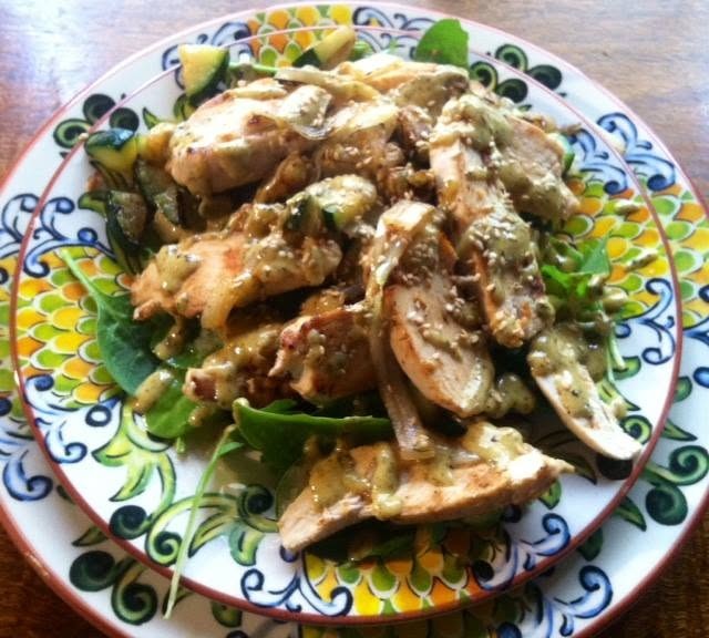 organic chicken salad with mustard dressing, sauerkraut, grilled onions and zucchini on a bed of fresh mixed greens