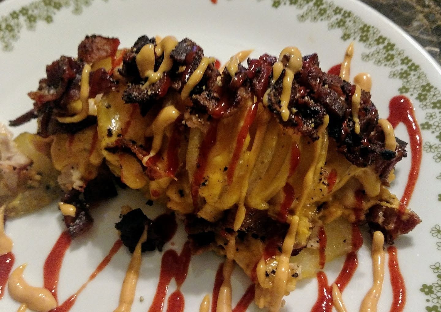 Stuffed Potato Snack Snack -potato, sliced turkey, bacon, extra sharp cheddar with a sriracha sauce and sriracha chili drizzle